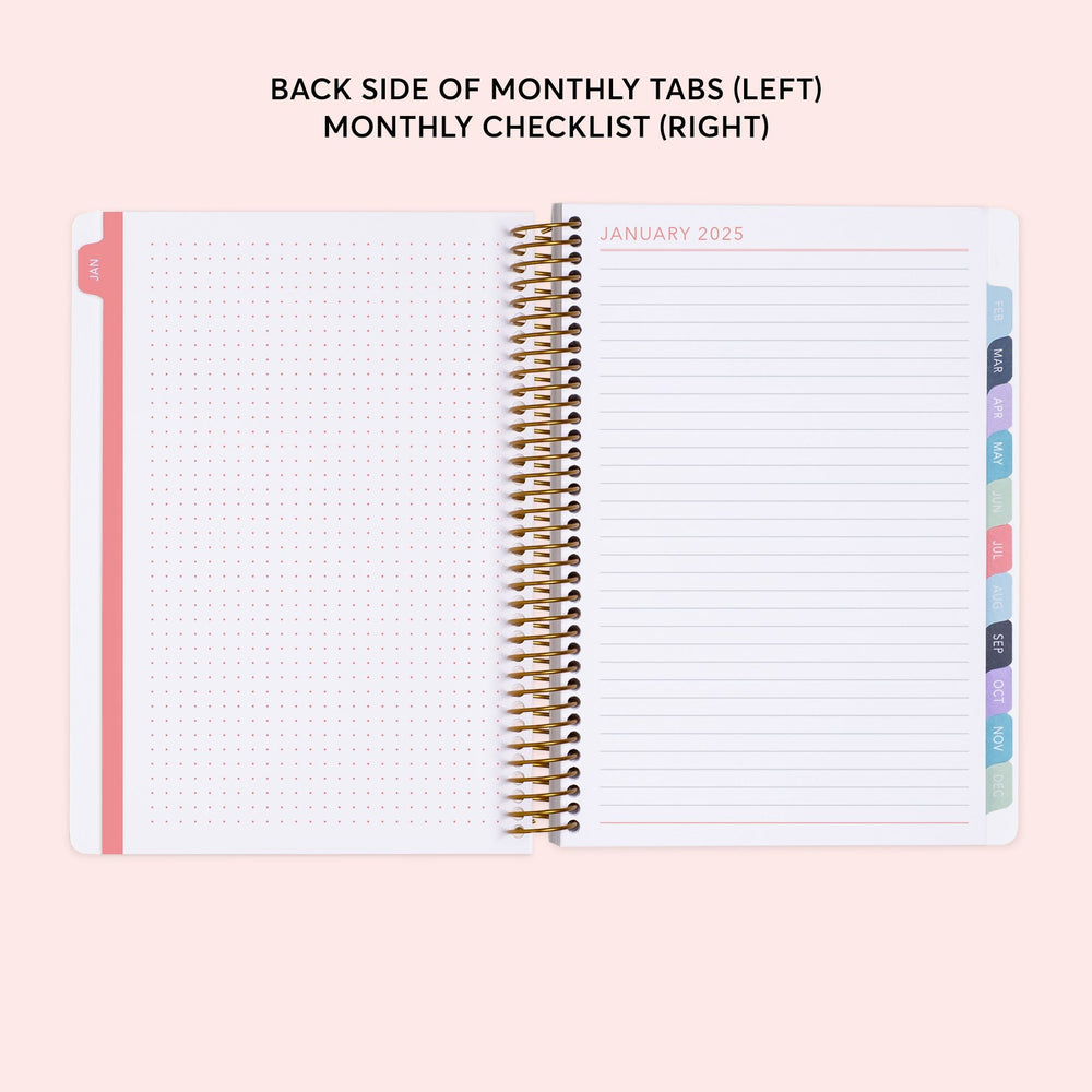 a planner with a pink cover and a pink background