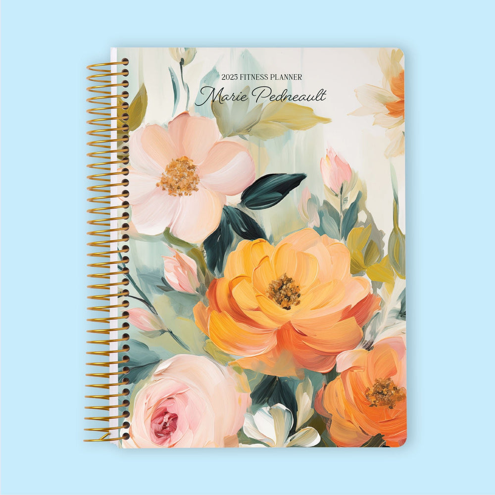Fitness planner with a Blossom Dreams Orange Green cover, a lively floral design for planning exercise routines and tracking progress.