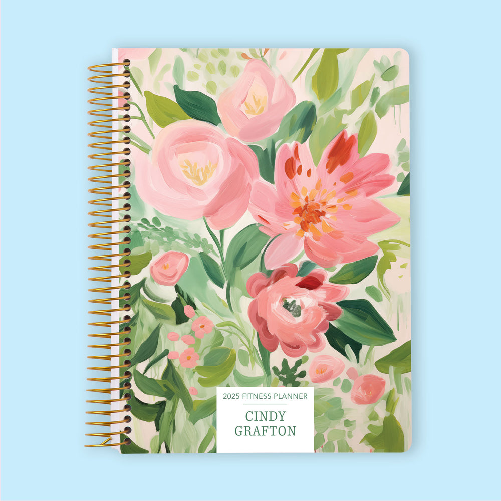 Fitness planner with a Blossom Dreams Pink Green cover, a beautifully illustrated planner for structured wellness and fitness organization.