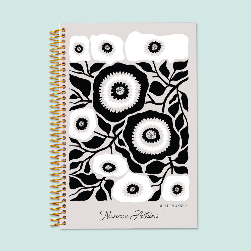 6x9 meal planner with an Artful Flowers Black and White cover, offering a timeless, elegant design with detailed meal tracking, grocery budgeting, and meal prep planning.