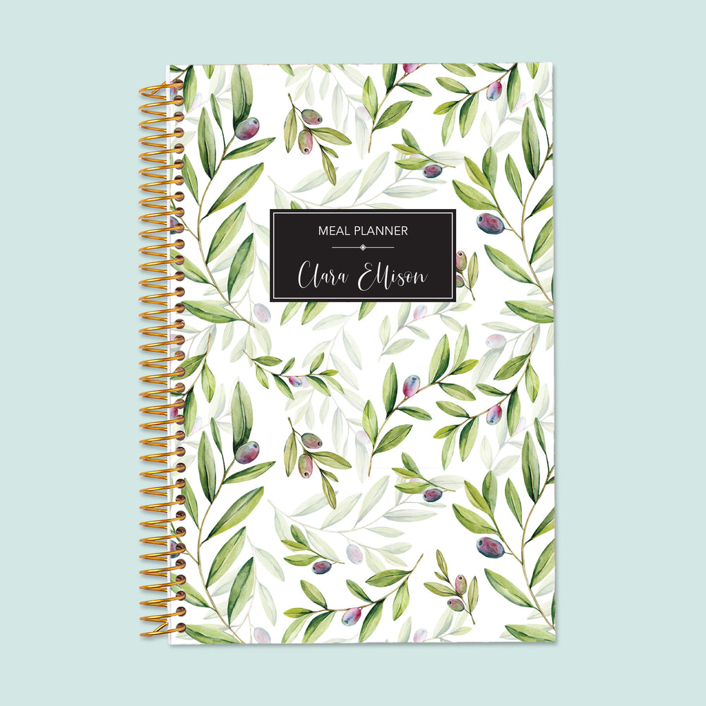 6x9 meal planner with an Olive Branches cover, offering sections for daily meal tracking, grocery budgeting, and healthy habit formation.