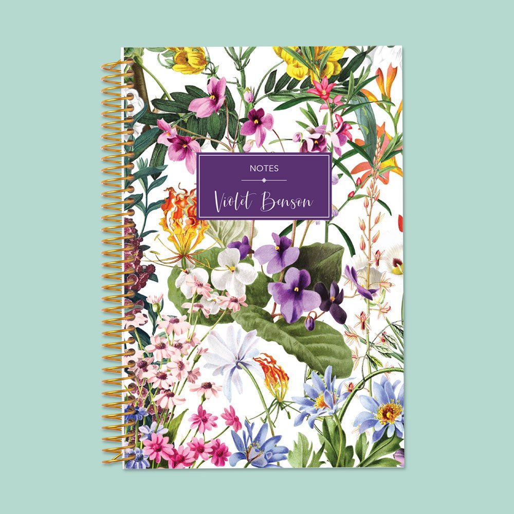 Elegant white floral notebook with colorful botanical details, premium paper, and spiral binding—ideal for notes, lists, and creative ideas.