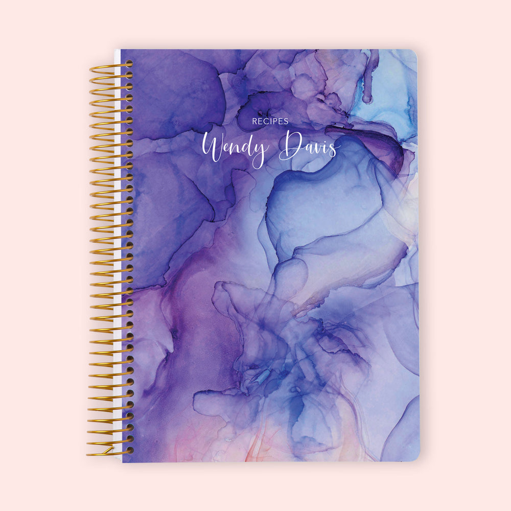 Personalized recipe book with a Purple Flowing Ink cover, featuring a vibrant marbled effect with dedicated pages for recipe instructions and ingredient tracking.