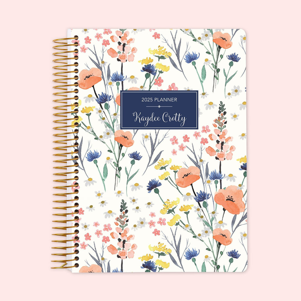 Weekly planner featuring a delicate blue wildflower cover inspired by meadow blooms, with gentle floral illustrations, robust spiral binding for everyday durability, and a personalized touch to help you stay organized.