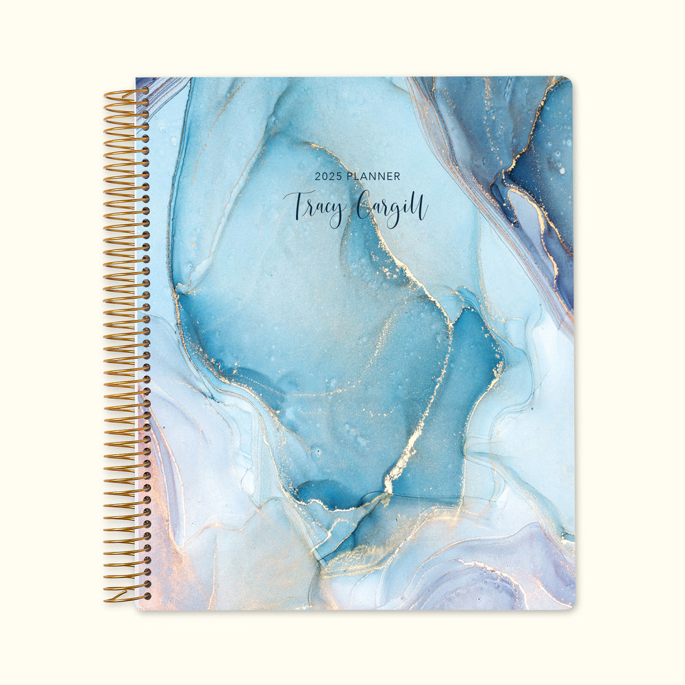 8.5x11 monthly planner with a luxurious aqua gold abstract ink cover, blending fluid gold accents with high-quality paper and structured monthly pages.