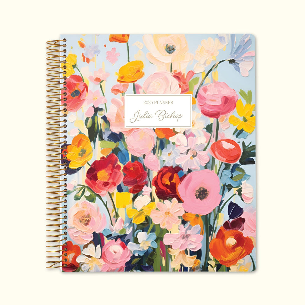 8.5x11 monthly planner with a vibrant Blossom Dreams colorful cover, featuring hand-painted florals, premium paper, and structured monthly layouts for seamless planning.