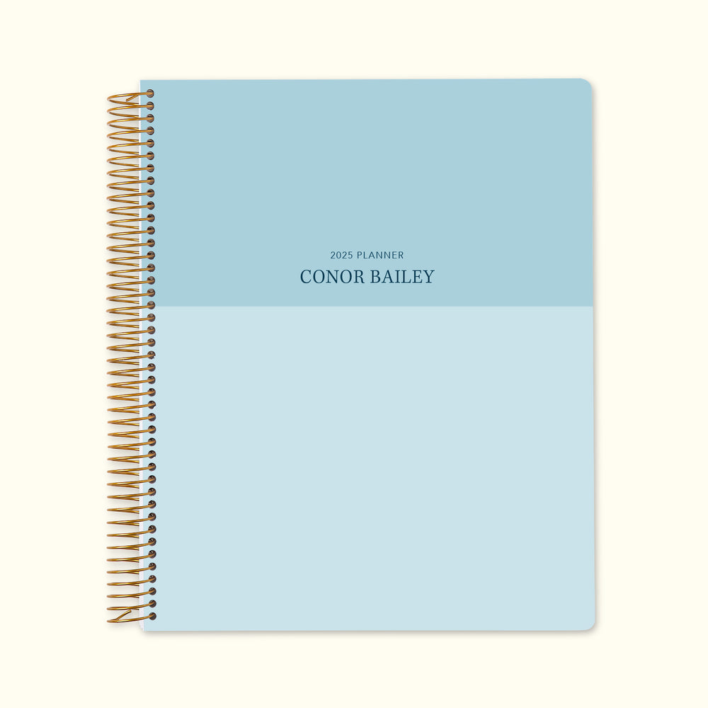 8.5x11 monthly planner with a stylish blue color block cover, offering a clean aesthetic, high-quality paper, and structured monthly planning pages for efficient organization.