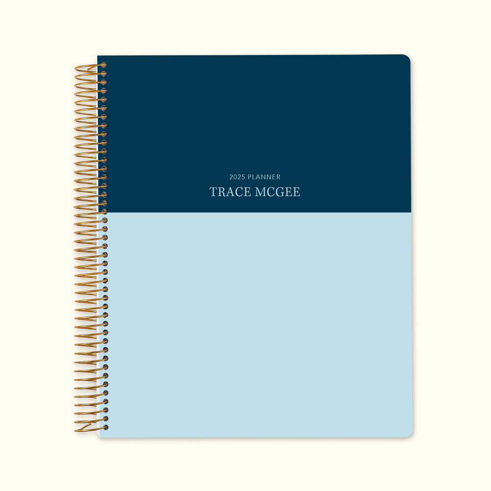 8.5x11 monthly planner with a refined blue navy color block cover, designed with smooth paper, coil binding, and spacious monthly layouts for a streamlined planning experience.