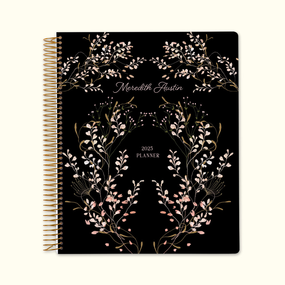 8.5x11 monthly planner with a floral pink frame cover, featuring intricate botanical details, durable paper, and functional monthly spreads for balanced organization.
