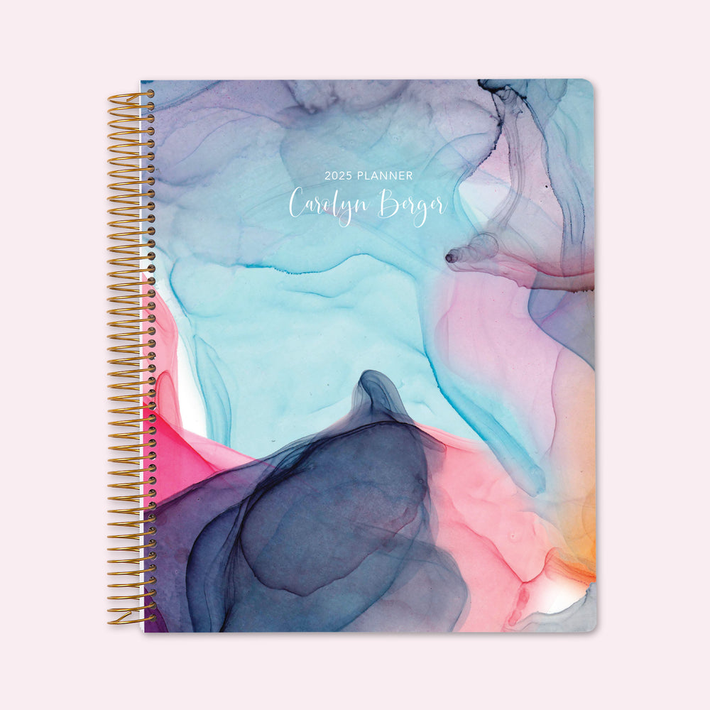 8.5x11 teacher planner with a rainbow flowing ink cover, featuring vibrant watercolor gradients, high-quality paper, and spacious planning layouts for educators.