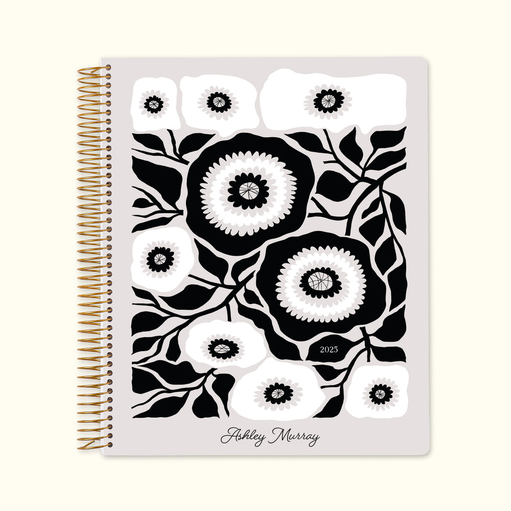 8.5x11 monthly planner with a sleek artful flowers black and white cover, combining monochrome elegance with premium paper and structured monthly planning layouts.