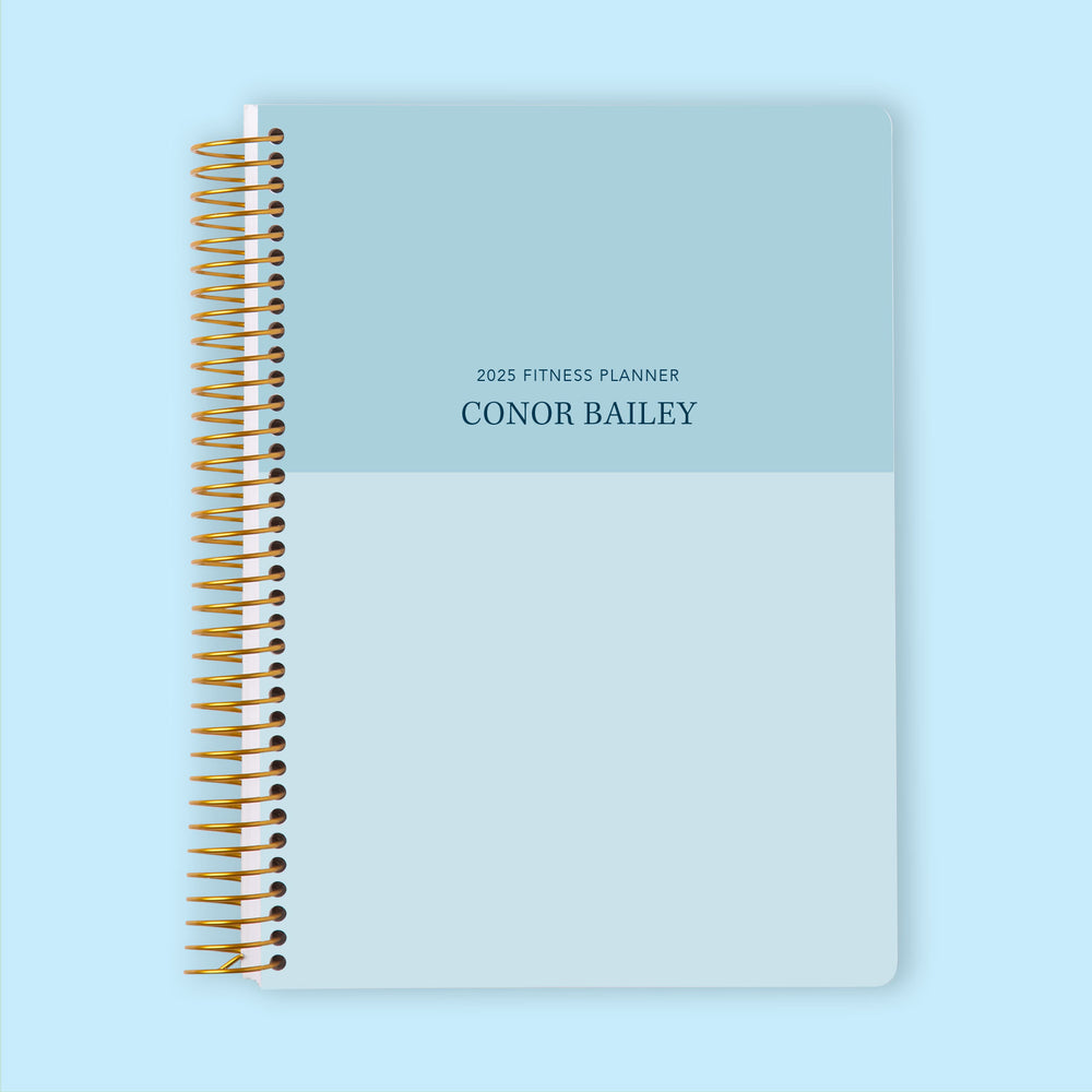Fitness planner with a Blue Color Block cover, designed to help structure workout schedules and track progress effortlessly.