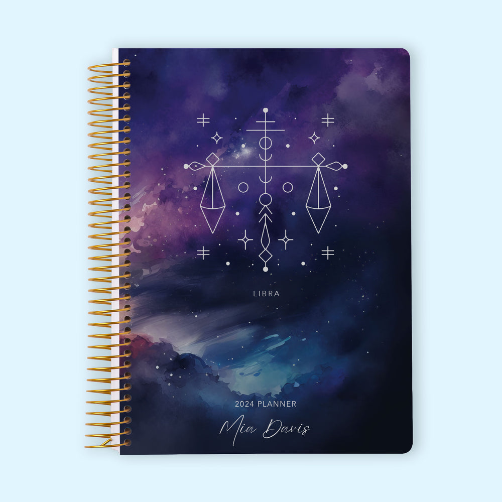 Monthly planner featuring an elegant Libra zodiac cover in cosmic blue and purple tones, symbolizing balance and harmony. Spiral bound for structured planning.