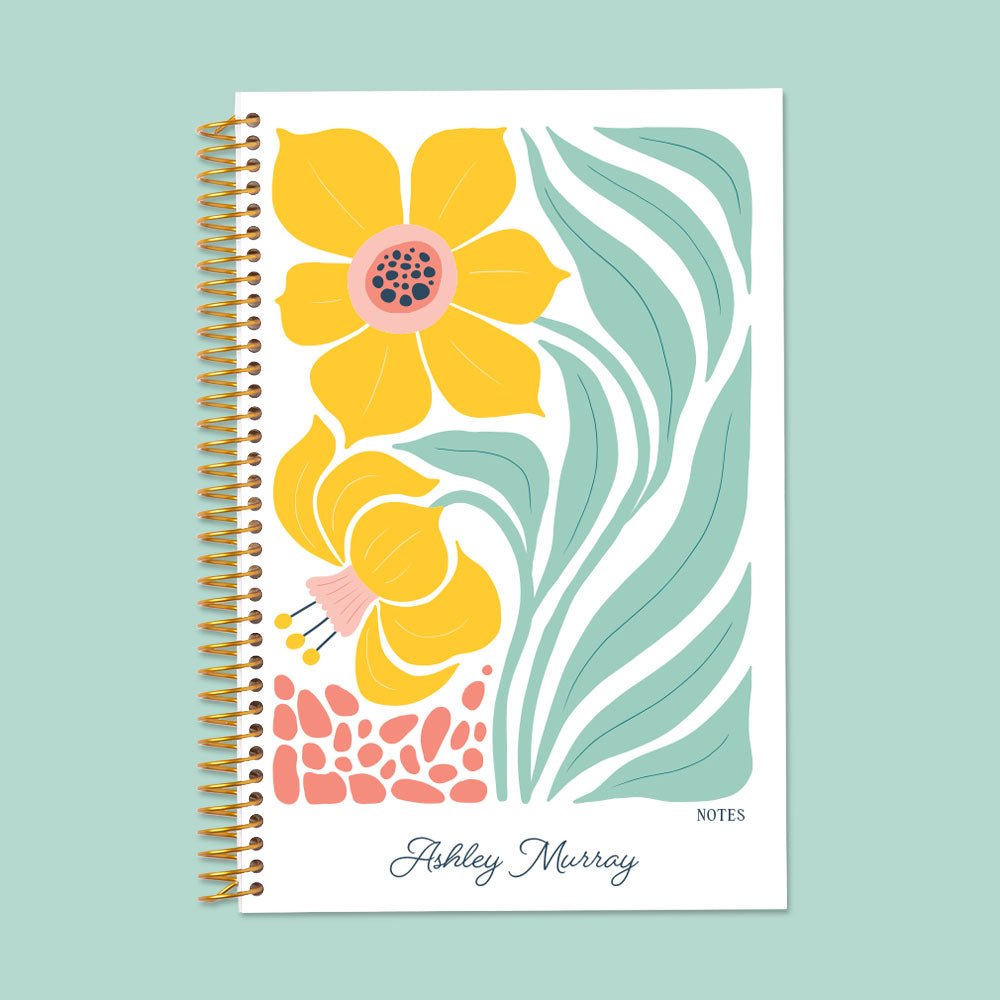 Artful yellow daffodil floral notebook with thick, smooth pages and a sturdy coil for seamless writing and planning.