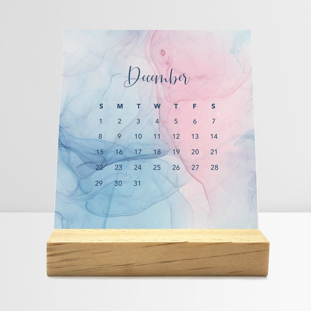 Posy Paper Co. 2024 desk calendar with flowing ink design displaying December dates.
