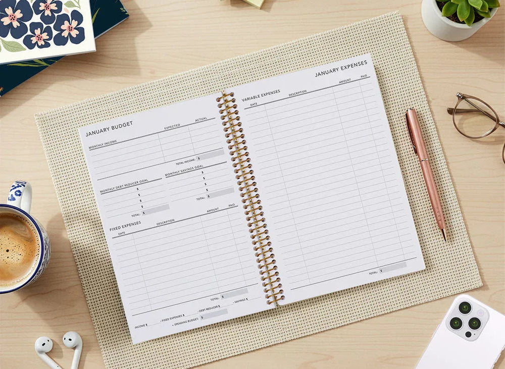 budget planner pages showing expense categories, savings chart and pen in hand