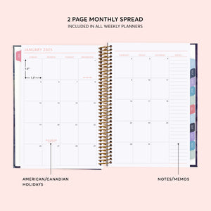 
                  
                    Two-page monthly calendar spread with a notes column and colored month tabs.
                  
                