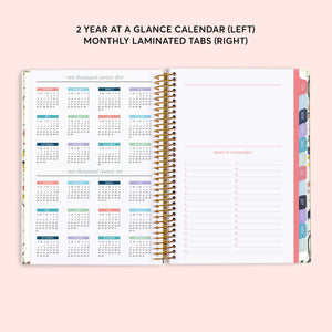 
                  
                    Two-year reference calendar beside a dates-to-remember page and colored month tabs.
                  
                
