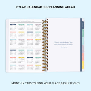 
                  
                    a planner with a notepad on top of it
                  
                