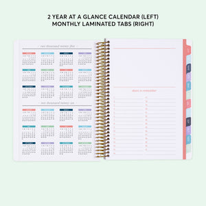 
                  
                    a planner with a calendar on top of it
                  
                