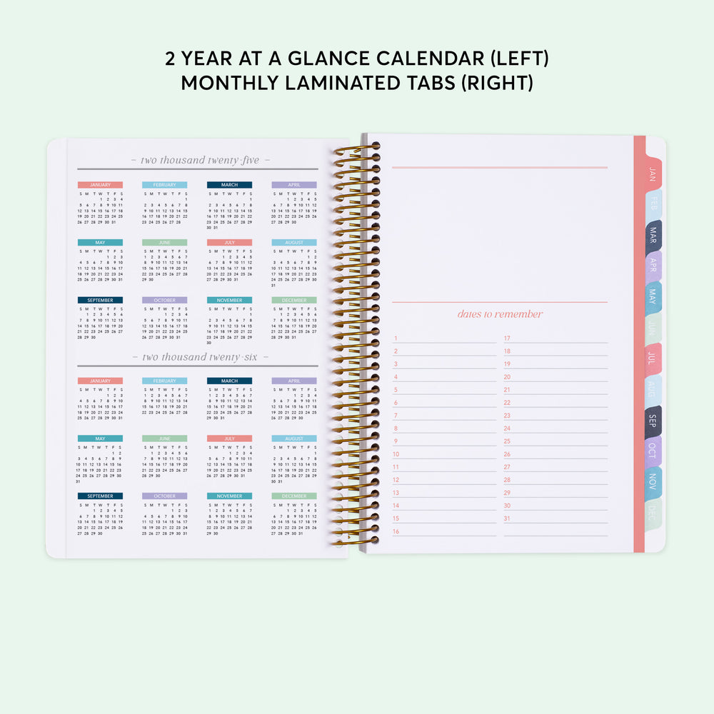 
                  
                    a planner with a calendar on top of it
                  
                