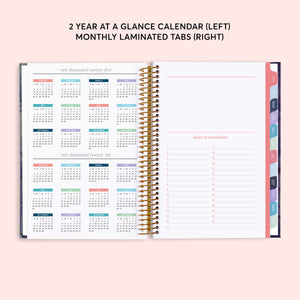 
                  
                    Two-year reference calendar beside a dates-to-remember page and colored month tabs.
                  
                