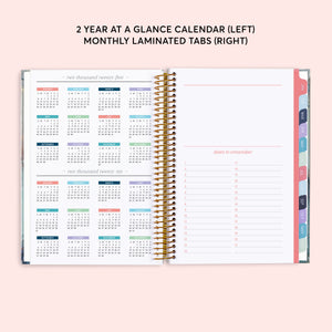 
                  
                    Two-year reference calendar beside a dates-to-remember page and colored month tabs.
                  
                