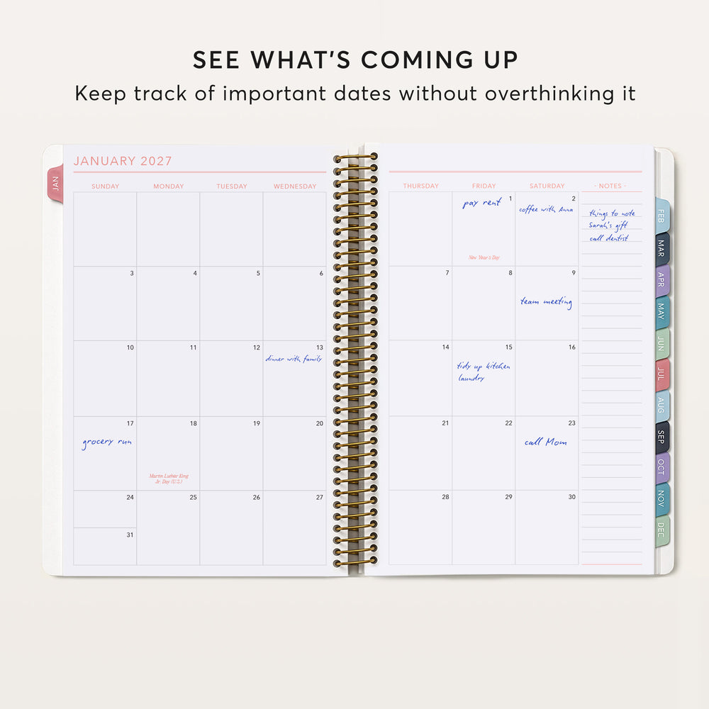 
                  
                    The image is a spiral-bound notebook with a calendar for January 2023. The notebook is open and displays the dates and events for the month.
                  
                