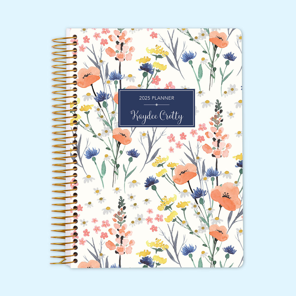 Daily planner with a charming blue wildflower cover design, featuring organized daily layouts and personalized cover options to help manage your schedule effortlessly.