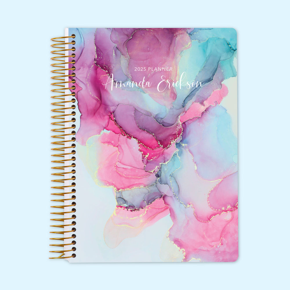 Daily planner with a vibrant pink and blue abstract ink cover design, including a well-organized daily page layout and personalized cover option to enhance your planning routine.