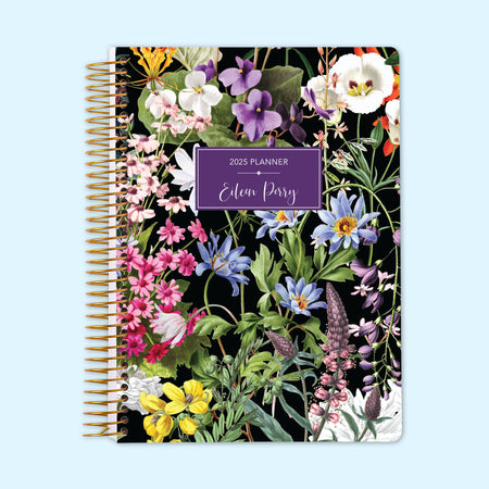 Monthly planner with bold florals on a black background, creating a dramatic, high-contrast botanical effect, bound with a strong spiral for durability.