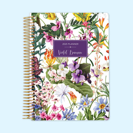 Monthly planner featuring subtle white floral accents against a minimalist background, creating a fresh, timeless look, bound with a durable spiral.