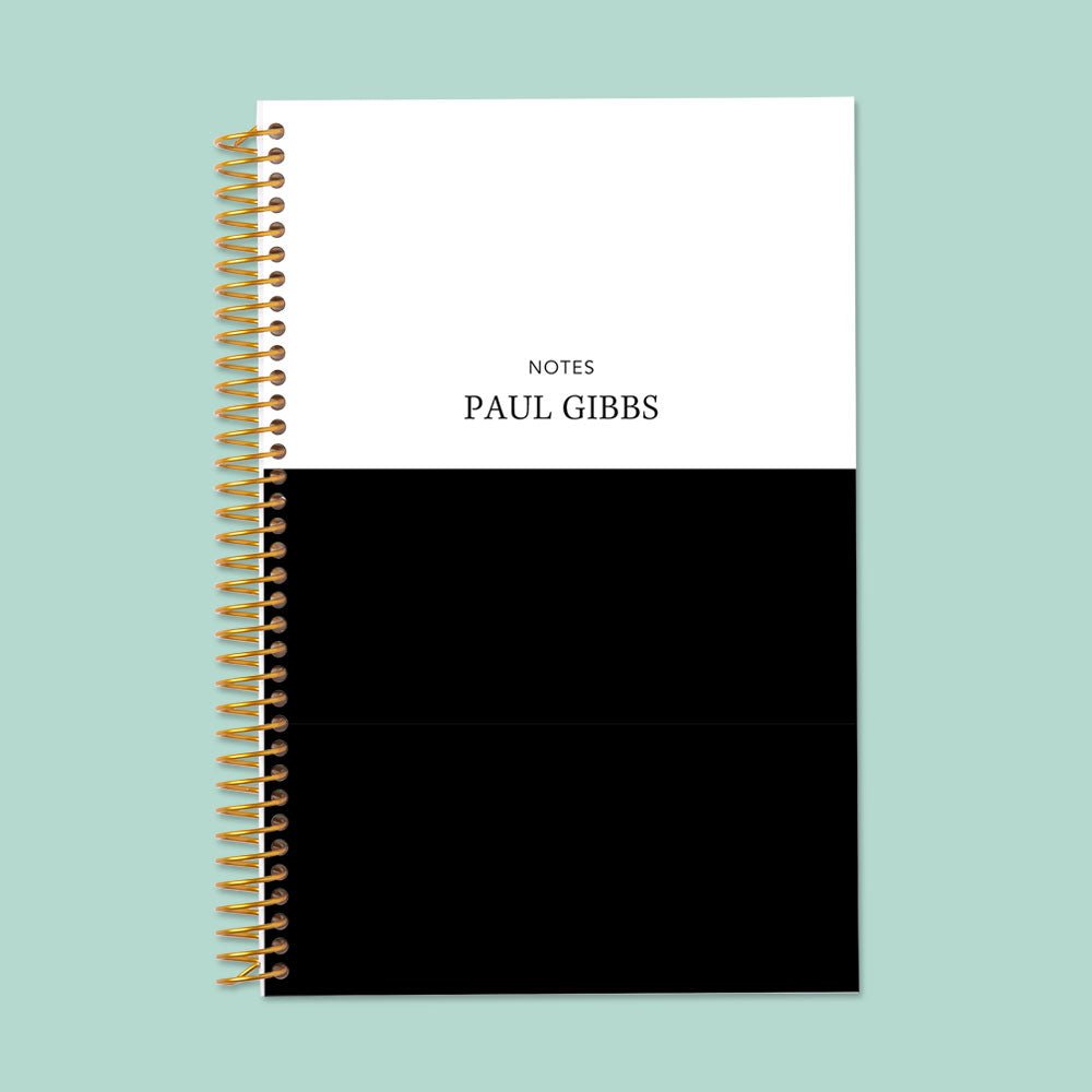 6×9 notebook with a Black White Color Block cover and gold coil binding.