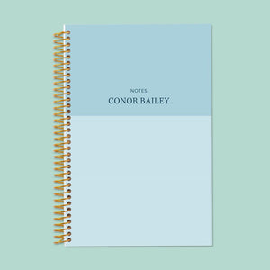 
                  
                    6×9 notebook with a Blue Color Block cover and gold coil binding.
                  
                