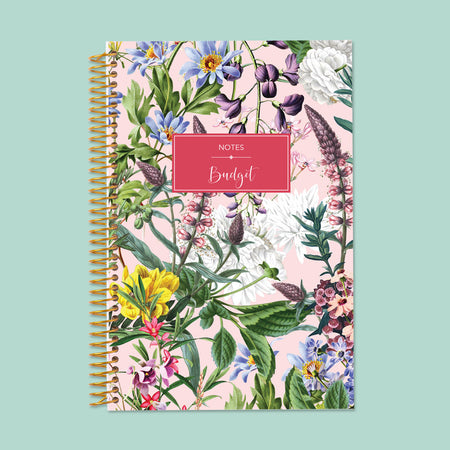 Vibrant pink floral notebook with bold botanical prints, smooth writing pages, and durable spiral binding—perfect for stylish note-taking.