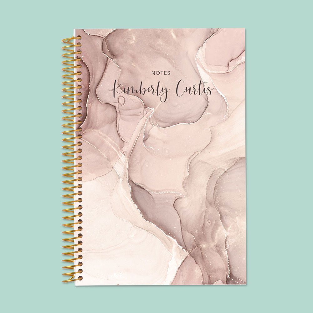 6×9 notebook with a Neutral Abstract Ink cover and gold coil binding.