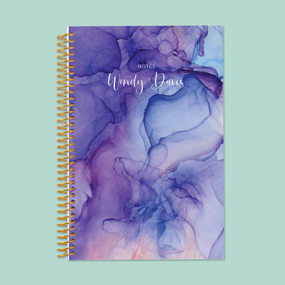 Artistic blue and purple flowing ink notebook, featuring thick, smooth pages and a sturdy binding for effortless writing.