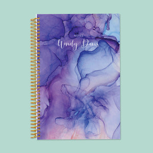 
                  
                    Artistic blue and purple flowing ink notebook, featuring thick, smooth pages and a sturdy binding for effortless writing.
                  
                