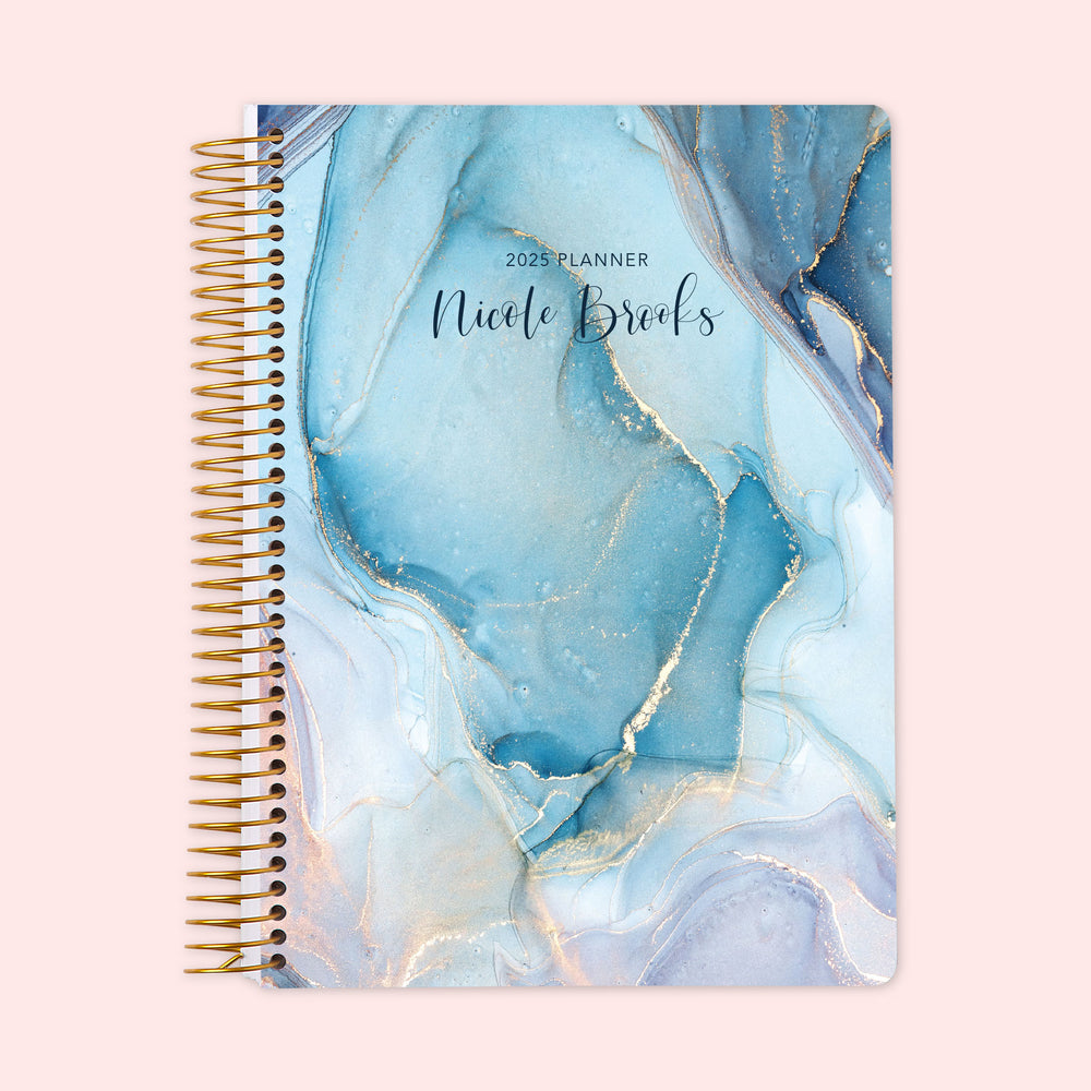 Weekly planner with a gorgeous aqua and gold abstract ink cover design, blending modern art style with sturdy spiral-bound durability and a personalized cover, to help you stay organized in style.