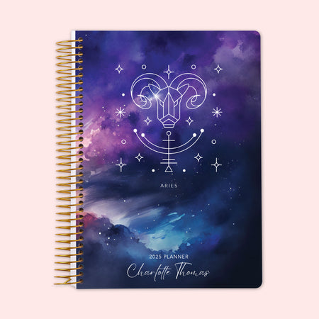 Weekly planner featuring an Aries zodiac cover with a cosmic purple backdrop and the Aries ram symbol, equipped with a durable spiral binding and personalized name on the cover — perfect for staying organized and inspired by the stars.