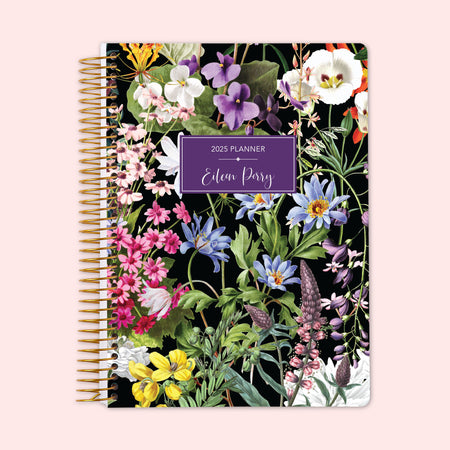 Weekly planner featuring a striking colorful floral cover on a black background — bright blooms that pop — with a reliable coil binding and option to personalize the cover, perfect for staying organized in style.