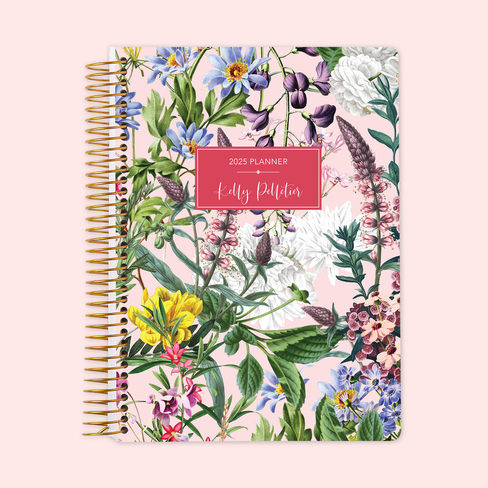 Weekly planner featuring a bright floral cover on a pink background, overflowing with colorful flowers, finished with a durable coil binding and personalized cover text to keep your planning organized and upbeat.