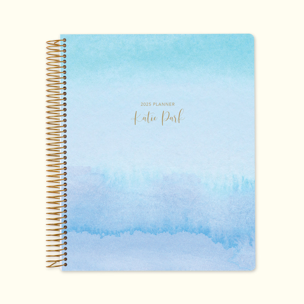 8.5x11 monthly planner with a tranquil blue lavender watercolor gradient cover, offering a serene aesthetic, high-quality paper, and structured monthly planning pages.