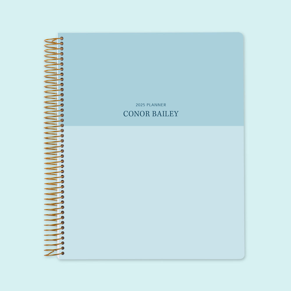 8.5x11 weekly planner with a minimalist blue color block cover, combining sleek design with premium-quality paper and structured weekly pages for planning ease.