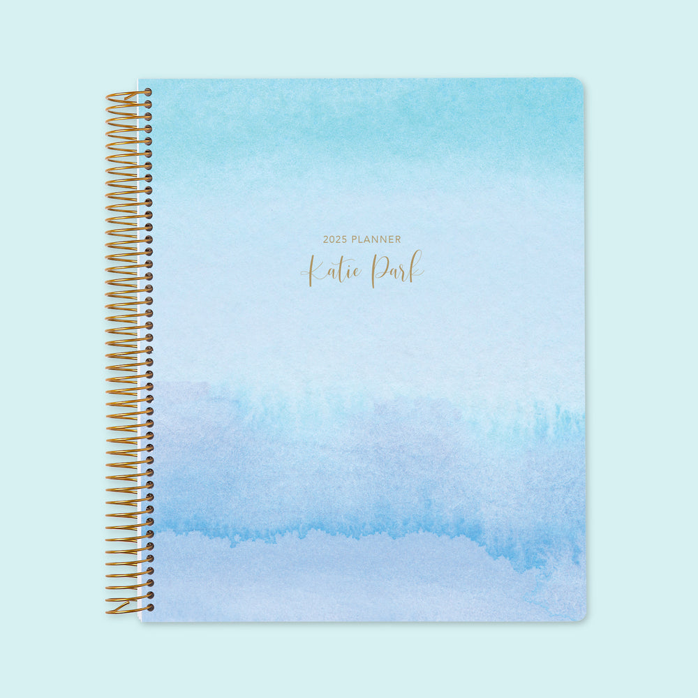 8.5x11 weekly planner with a tranquil blue lavender watercolor gradient cover, offering a serene aesthetic, premium writing paper, and well-organized weekly planning pages.