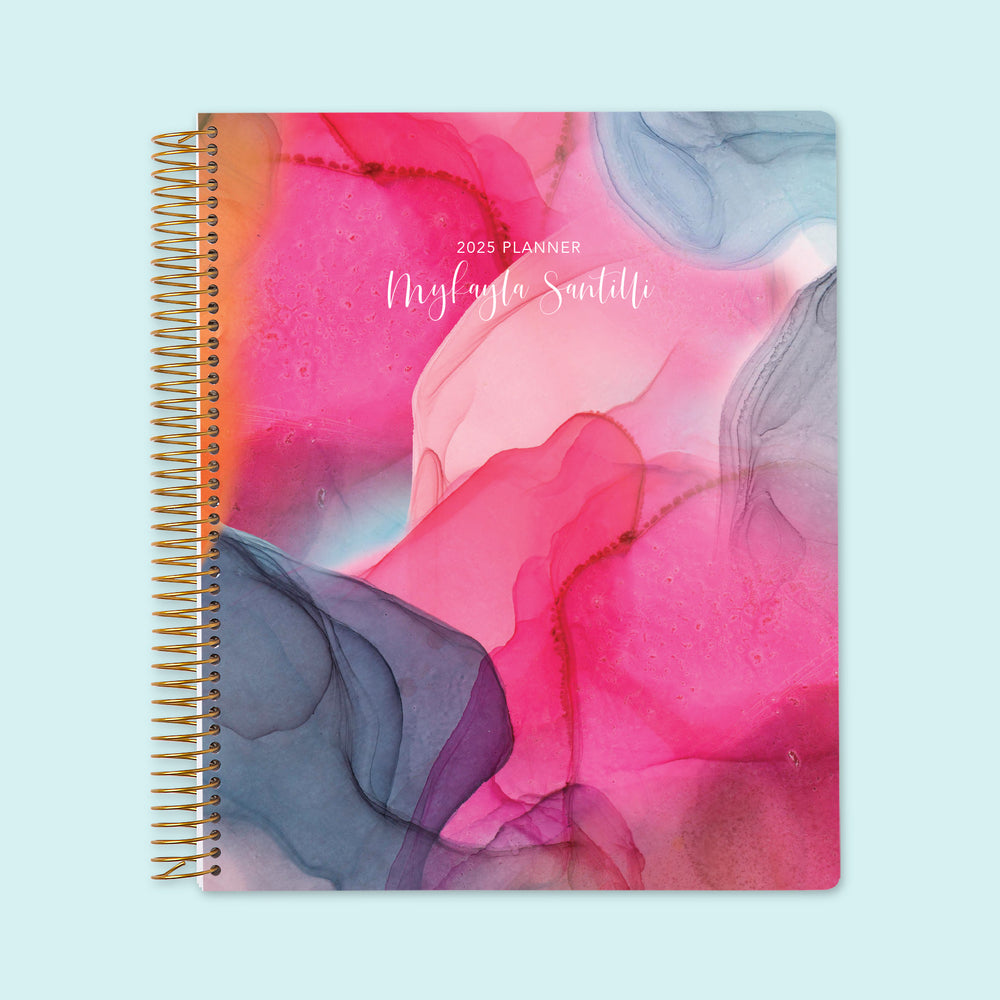 8.5x11 weekly planner with a bold hot pink and gray flowing ink cover, designed with striking abstract patterns, smooth writing paper, and spacious weekly layouts.