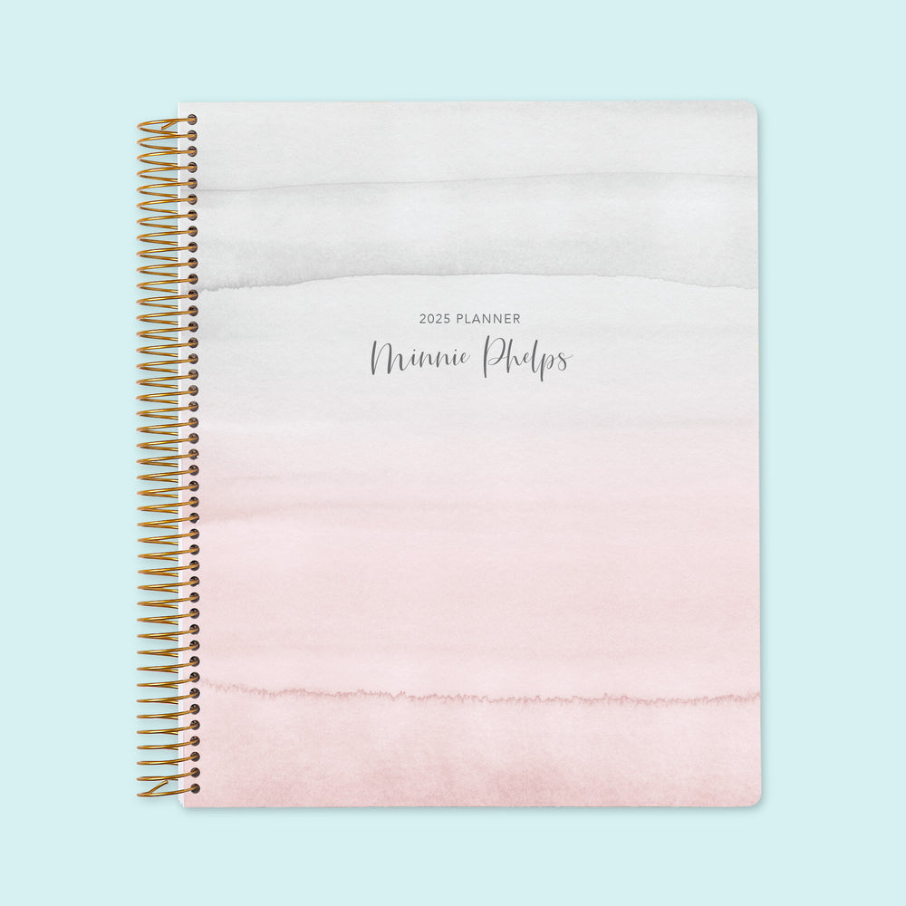 8.5x11 weekly planner with a gentle pink and gray watercolor gradient cover, designed with smooth paper, spacious weekly pages, and a calming aesthetic for mindful planning.