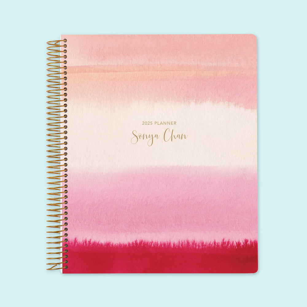 8.5x11 weekly planner with a dreamy pink watercolor gradient cover, featuring delicate washes of color, premium paper, and structured weekly layouts for smooth planning.