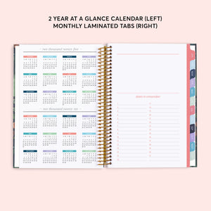 
                  
                    Two-year reference calendar beside a dates-to-remember page and colored month tabs.
                  
                