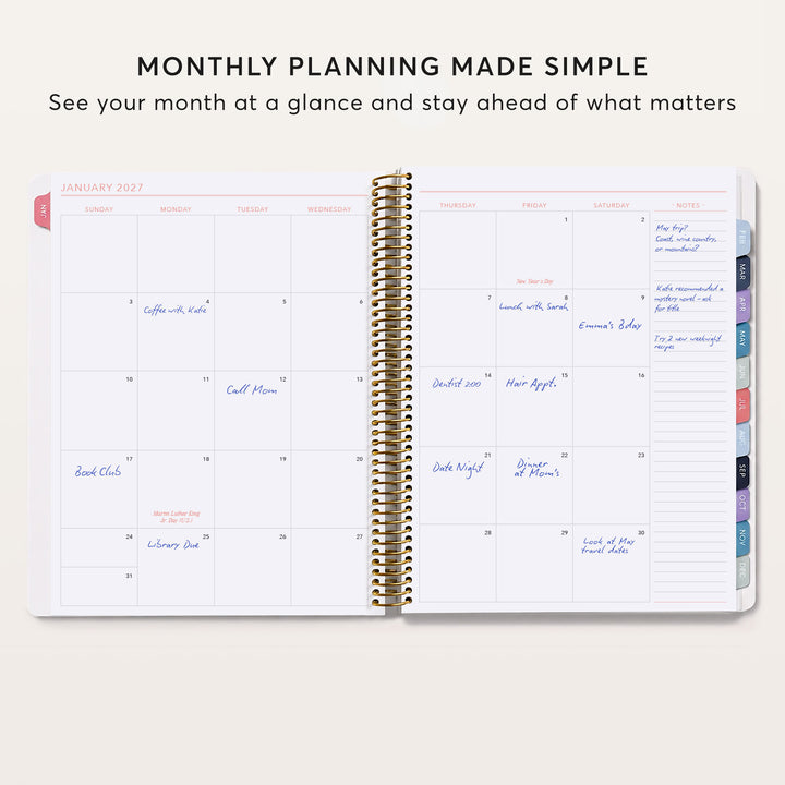 Open monthly planner showing a filled-in calendar spread, notes column and colored month tabs.